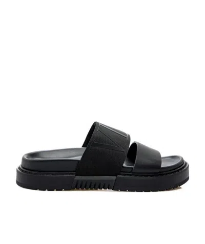 Valentino Garavani Logo-embossed Leather Slides In Black