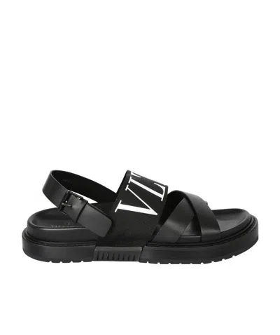 Valentino Garavani Logo-print Crossover-strap Sandals In Black