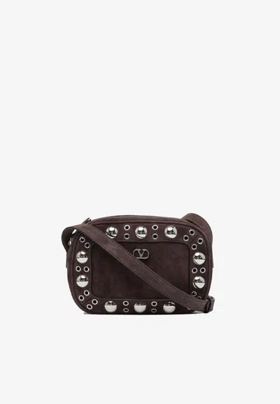 Valentino Garavani Dome-shaped Crossbody Bag With Metallic Eyelets And Adjustable Strap In Brown