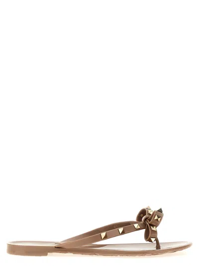 Valentino Garavani Mini Bow Sandals With Platinum-finish Studs And Thece Motif In Pink