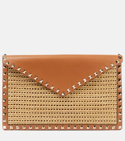 Valentino Garavani Rockstud Large Leather-trimmed Raffia Clutch In Brown