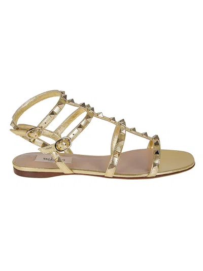 Valentino Garavani Rockstud Nappa Laminated Flat Sole Sandals In Gold