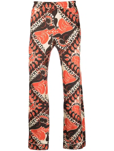 Valentino Stylish Ss23 Pants In St. Archive Manifesto Bandana Arancio For Men In Orange