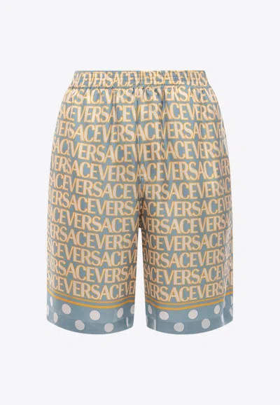 Versace All-over Logo Silk Shorts In Blue