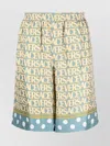 Versace Silk Bermuda Shorts With All-over Logo In Yellow