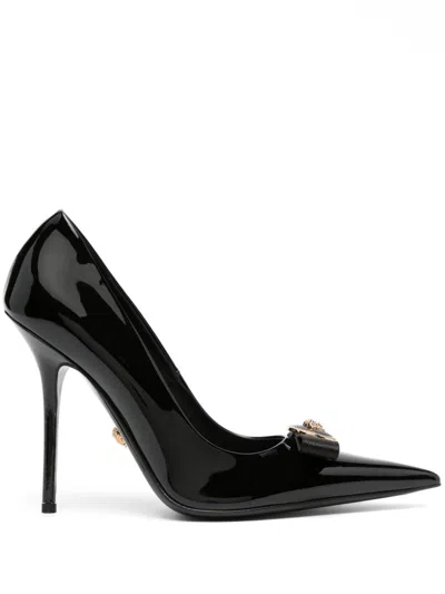 VERSACE BLACK PATENT LEATHER PUMPS WITH MEDUSA HEAD MOTIF AND BOW DETAILING