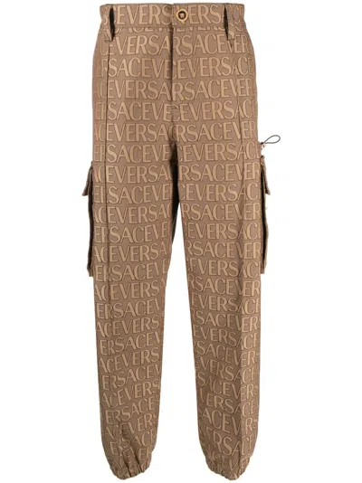 Versace Utility Cargo Pants With All Over Logo Pattern In Brown