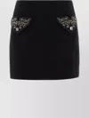 Versace Chic Fitted Mini Skirt With Embellished Pockets In Black