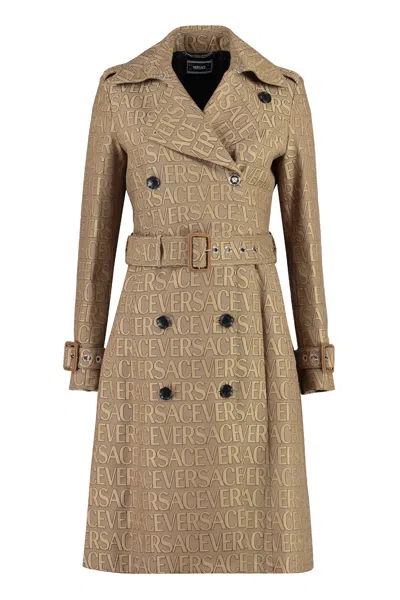 Versace All Over Logo Trench Coat In Beige