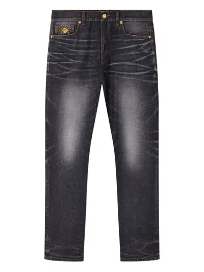 VERSACE FADED BLACK JEANS WITH MEDUSA DETAIL
