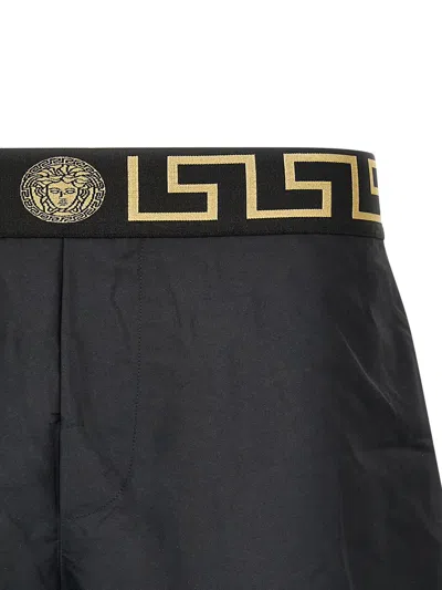 VERSACE BLACK SWIMSUIT SHORTS WITH GRECA DETAIL IN TECH FABRIC MAN