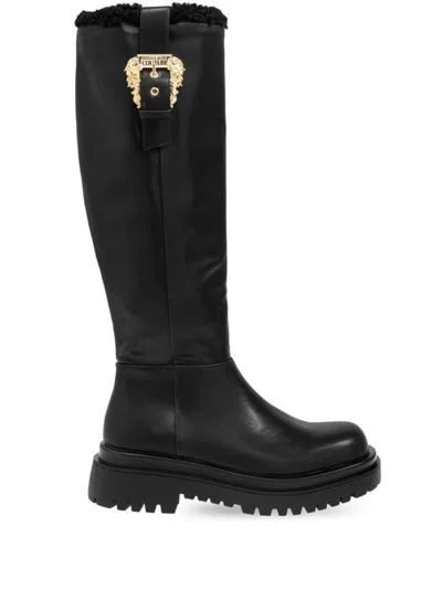 VERSACE JEANS COUTURE VERSACE JEANS COUTURE ANKLE BOOTS WITH PLUSH CUFF AND STATEMENT BUCKLE DETAIL