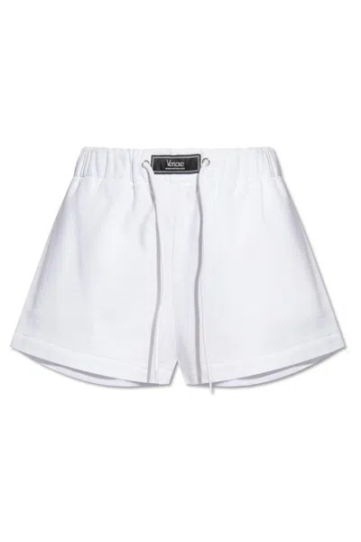 Versace Logo-embellished Elasticated Waistband Shorts In White+crystal