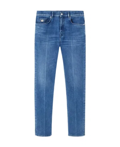 Versace Logo-patch Slim-cut Denim Jeans In Blue