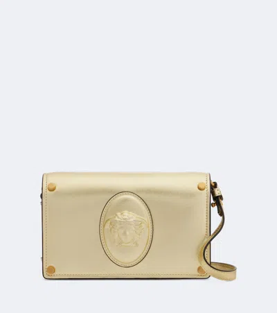 Versace Medusa Small Metallic Leather Clutch In Gold