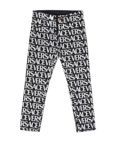 Versace Metallic Logo Print Jeans In Black