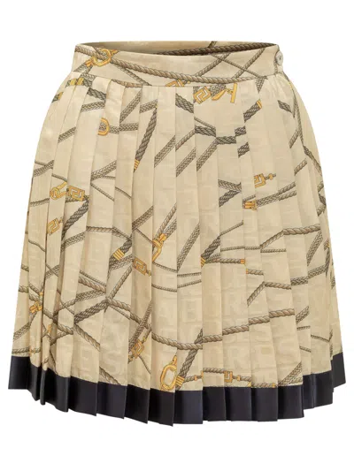 VERSACE PALE YELLOW PLEATED MINI SKIRT WITH ALL-OVER LOGO PRINT IN SILK BLEND WOMAN