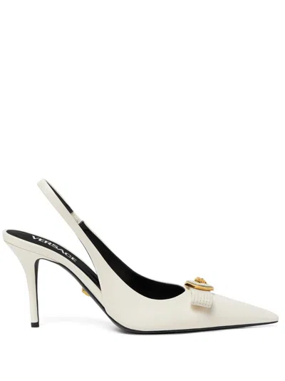 Versace Pointed Toe Slingback Heels With Textured Bow And Gold Medallion In White
