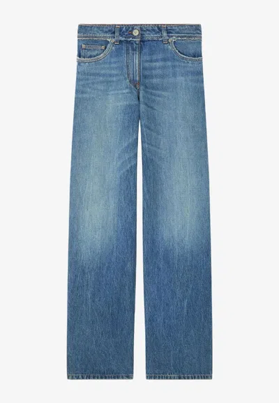Versace Raw Cut Frayed Jeans In Blue