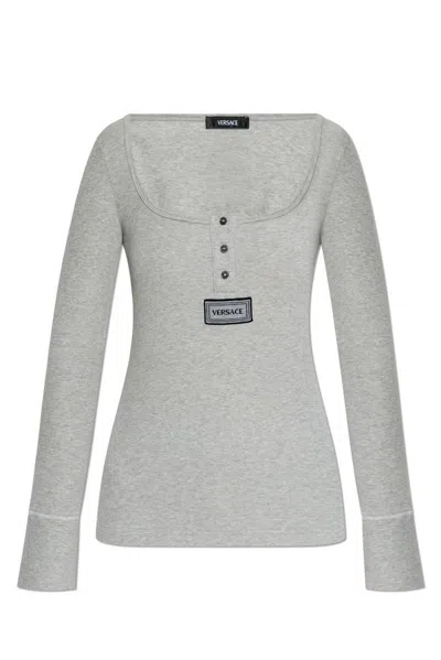 Versace Logo Tag Long-sleeved Ribbed Top In Grey