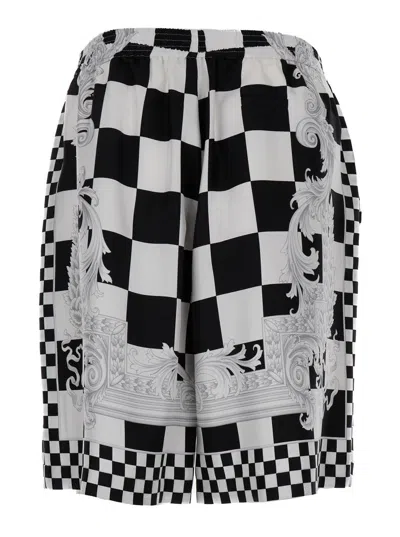 VERSACE BLACK AND WHITE SHORTS WITH BAROQUE PRINT IN TECHNO FABRIC MAN