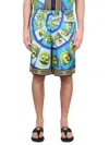 Versace Le Maschere Print Silk Shorts In Blue