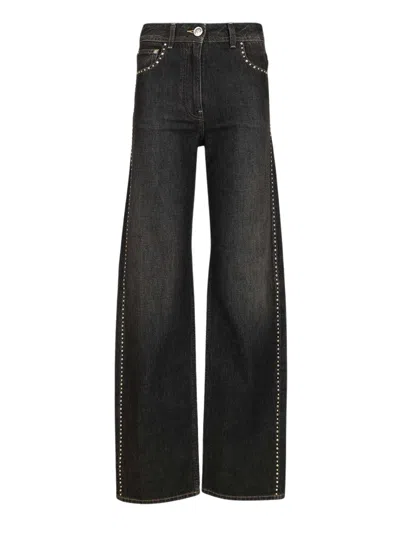 Versace Studded Denim Trousers In Black