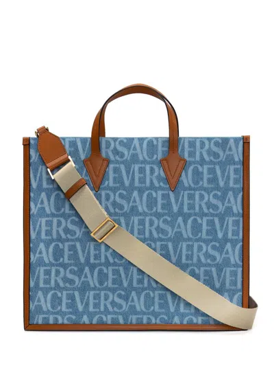 VERSACE TOTE BAG WITH ALL-OVER LOGO PRINT IN LIGHT BLUE CANVAS MAN