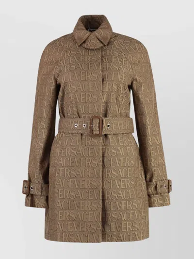 VERSACE TRENCH COAT WITH ALLOVER MOTIF AND BELTED WAIST