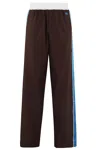 Wales Bonner Logo Embroidered Side Stripe Detailed Trousers In Dark Brown And Blue