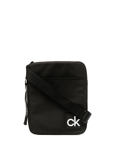 Shop Calvin Klein Logo Patch Zipped Messenger Bag In Black