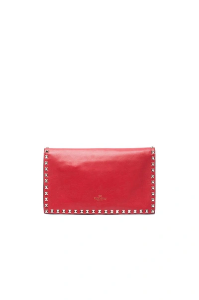 Shop Valentino Rockstud Flap Clutch In Red