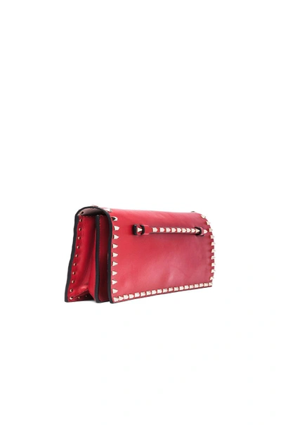 Shop Valentino Rockstud Flap Clutch In Red