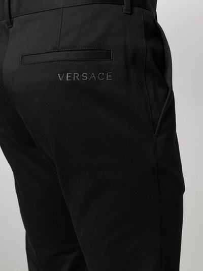 Shop Versace Embroidered Logo Tailored Trousers In Black