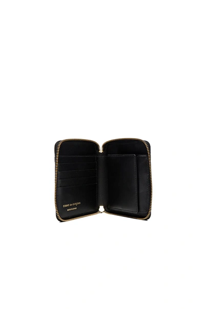 Shop Comme Des Garçons Clover Embossed Zip Fold Wallet In Black