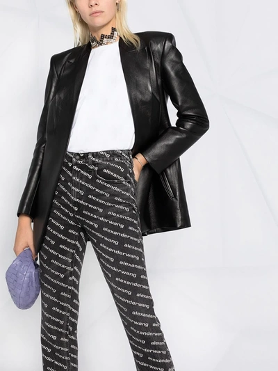 Shop Alexander Wang Mid-rise Logo-print Flared Trousers In Black