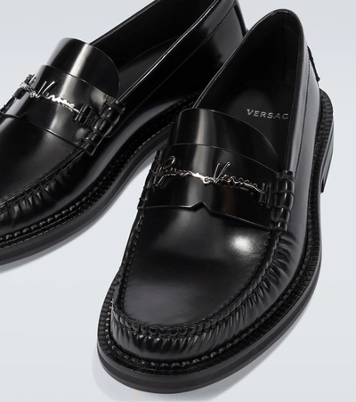 Shop Versace Gv Signature Leather Loafers In Black