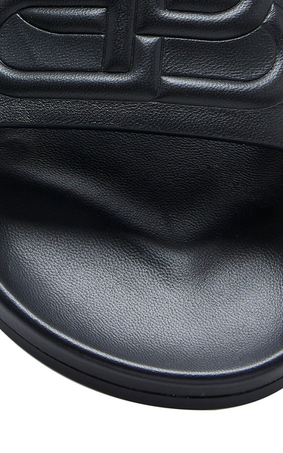 Shop Balenciaga Logo-embossed Leather Slides In Black