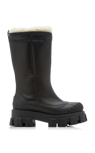 Shop Prada Monolith Shearling-trimmed Leather Boots In Black