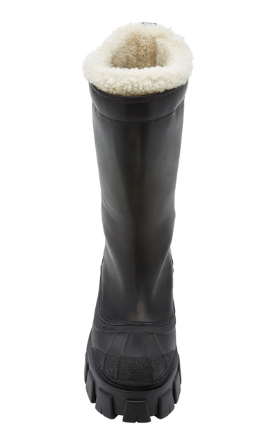 Shop Prada Monolith Shearling-trimmed Leather Boots In Black