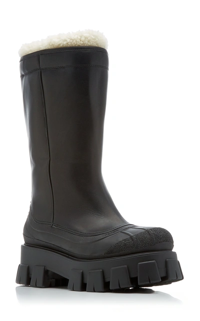 Shop Prada Monolith Shearling-trimmed Leather Boots In Black