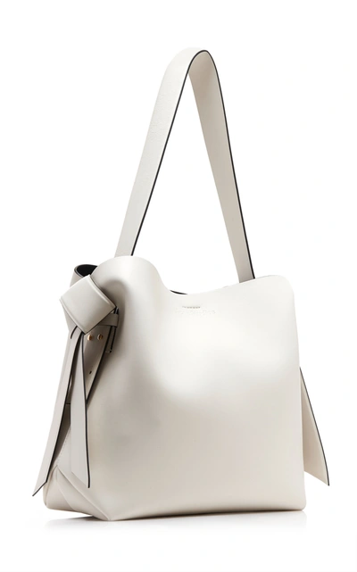 Shop Acne Studios Msubi Midi Knotted Leather Shoulder Bag In Black/white