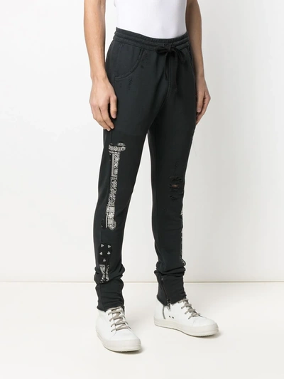 Shop Alchemist Bandana-print Ripped Track-pants In Black