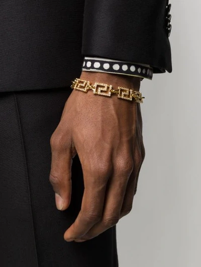 Shop Versace Greek Key Bracelet In Gold