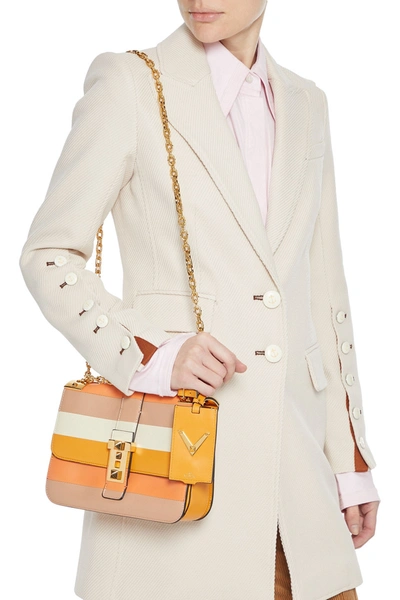 Shop Valentino B-rockstud Striped Paneled Leather Shoulder Bag In Pastel Orange