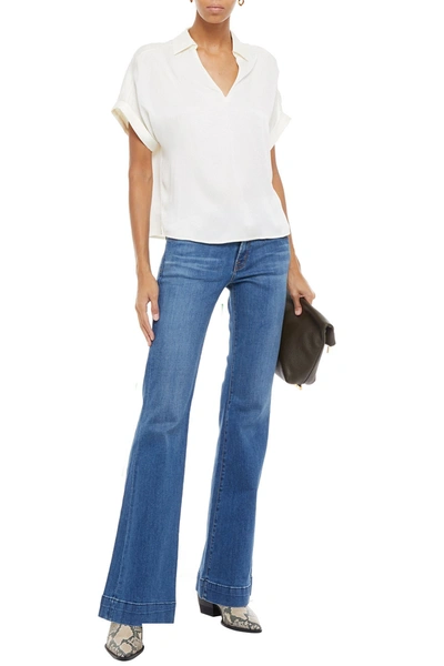 Shop J Brand Distressed Low-rise Flared Jeans In Mid Denim