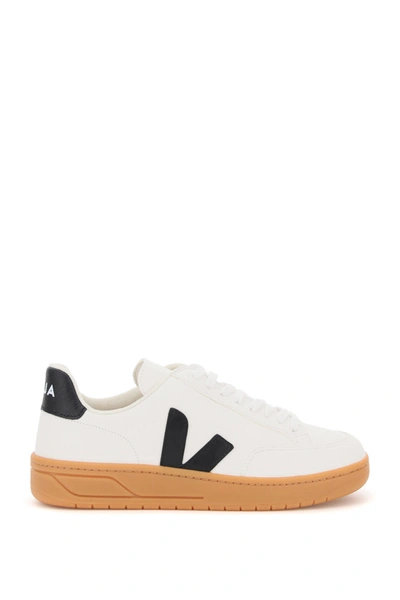 Shop Veja V-12 Leather Sneakers In Extra White Black Gum Sole (white)
