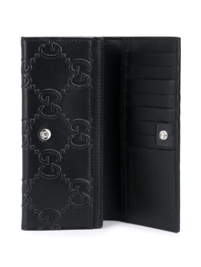 Shop Gucci Gg Embossed Wallet In Black