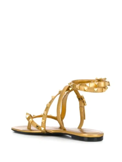 Shop Valentino Rockstud Flair Sandals In Gold