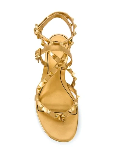Shop Valentino Rockstud Flair Sandals In Gold